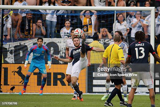 New England Revolution's Patrick Mullins tries a bicycle kick in front of Los Angeles Galaxy's Jaime Penedo . The Los Angeles Galaxy defeated the New...