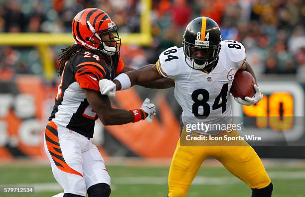 Pittsburgh Steelers wide receiver Antonio Brown fights to break free from Cincinnati Bengals' Adam Jones during the second half of play in their NFL...