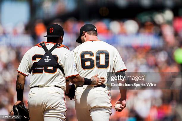 San Francisco Giants relief pitcher Hunter Strickland and San Francisco Giants catcher Hector Sanchez confer in the 7th inning, during the MLB...