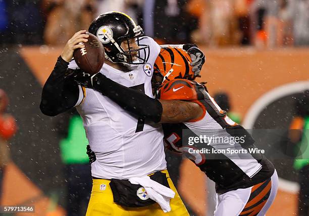 Pittsburgh Steelers quarterback Ben Roethlisberger is sacked by Cincinnati Bengals' A.J. Hawk during the second half of play in their NFL Wild Card...