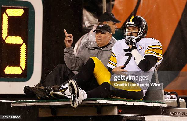 Pittsburgh Steelers quarterback Ben Roethlisberger is taken off the field injured after being sacked by Cincinnati Bengals' A.J. Hawk during the...