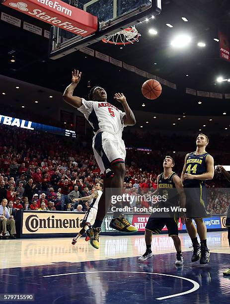 Arizona Wildcats forward Stanley Johnson celebrates a dunk over Michigan Wolverines guard Spike Albrecht and forward Max Bielfeldt during the first...