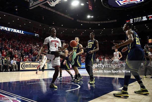 Arizona Wildcats forward Stanley Johnson celebrates a dunk over Michigan Wolverines guard Spike Albrecht and forward Max Bielfeldt during the first...