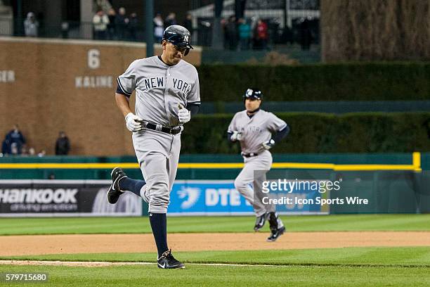 New York Yankees designated hitter Alex Rodriguez jogs to home plate to score a run on teammate Mark Teixeira's three-run home run during the seventh...