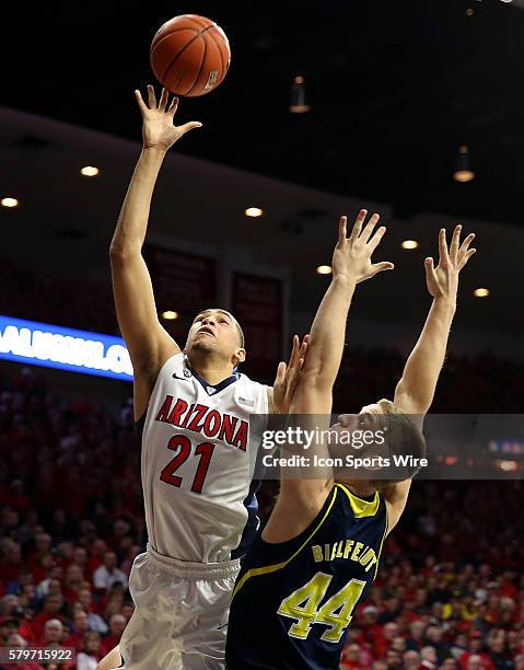 Arizona Wildcats forward Brandon Ashley shoots over Michigan Wolverines forward Max Bielfeldt during the first half of the college basketball game...