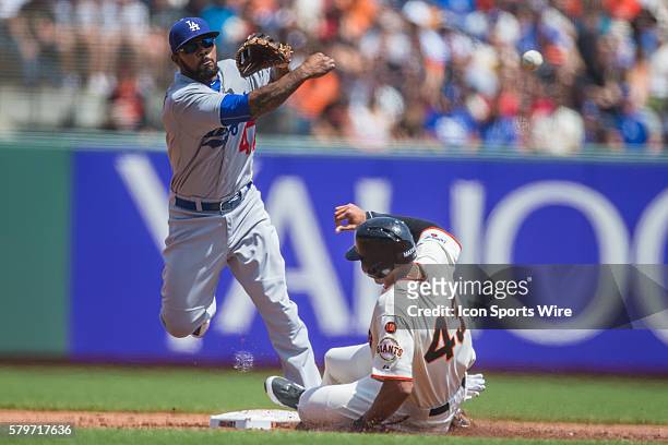 San Francisco Giants right fielder Justin Maxwell slides into 2nd base too late, as Los Angeles Dodgers second baseman Howie Kendrick makes the...