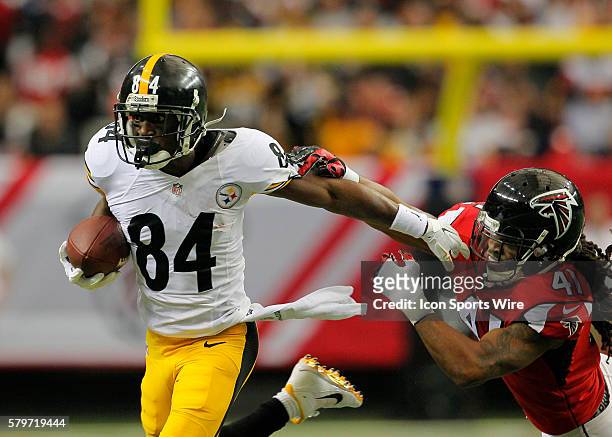 Pittsburgh Steelers wide receiver Antonio Brown stiff arms Atlanta Falcons free safety Dezmen Southward in first half action of the Pittsburgh...
