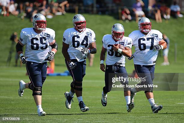 New England Patriots tackle Jordan Devey , offensive lineman Chris Barker , and New England Patriots offensive lineman Josh Kline escort New England...