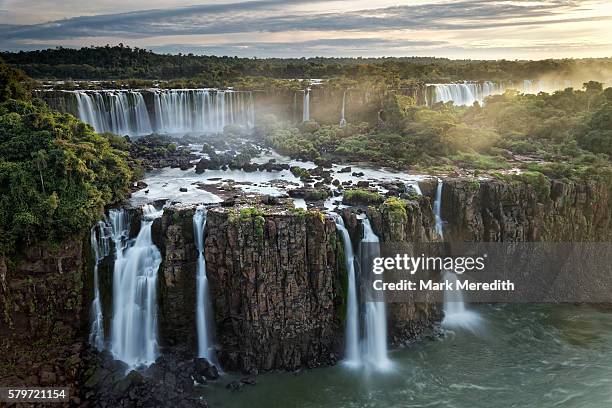 three musketeers falls at iguazu falls, and the rivadavia falls on the argentine side at the back - cataratas del iguazú fotografías e imágenes de stock