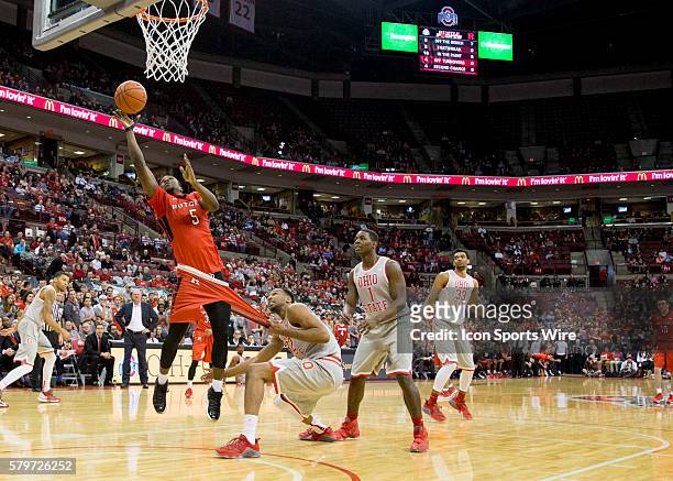 Jan 13, 2016; Columbus, OH, USA; Ohio State Buckeyes center Trevor Thompson fouls Rutgers Scarlet Knights guard Mike Williams as he attempts a lay up...