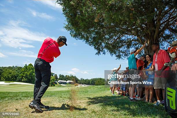 Tiger Woods hits his second shot from the rough during the final round of the Quicken Loans National at Robert Trent Jones Golf Course in...