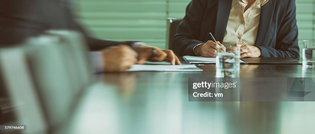Businessman and businesswoman signing a contract