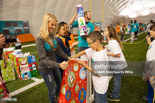 Lauren Tannehill handing out gifts. Miami Dolphins players, coaches, cheerleaders, Miami Dolphins Women's Organization members and mascot T.D, will...