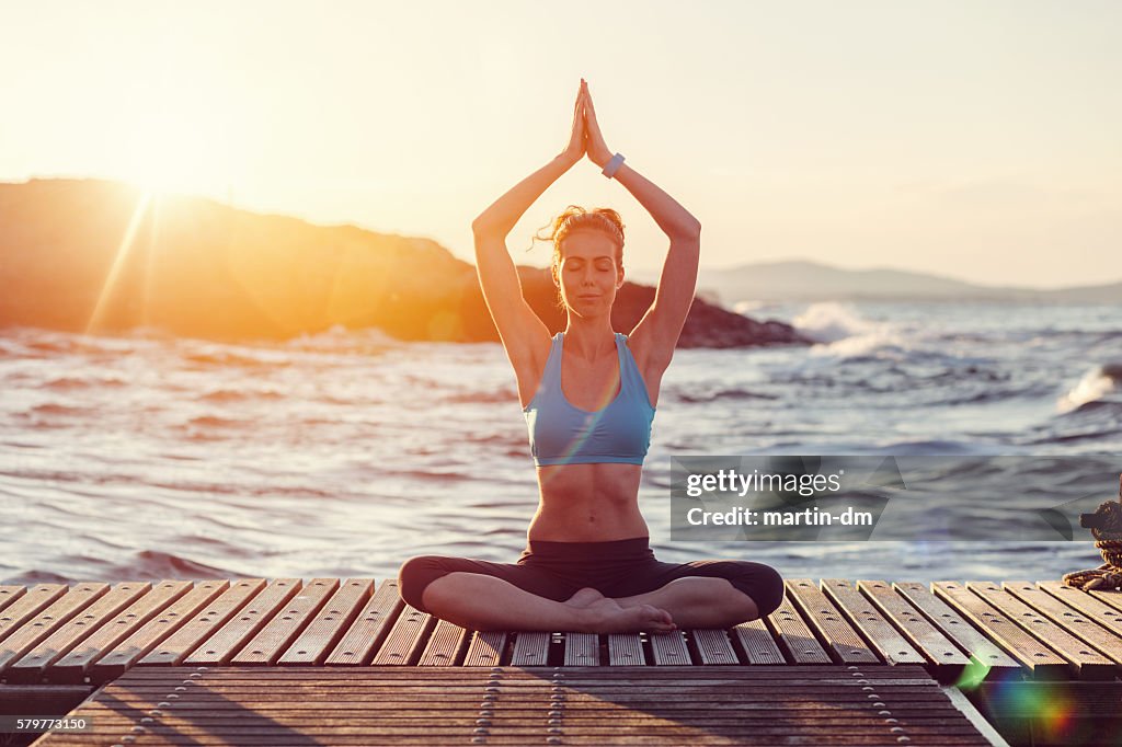 Sports woman meditating in a prayer position