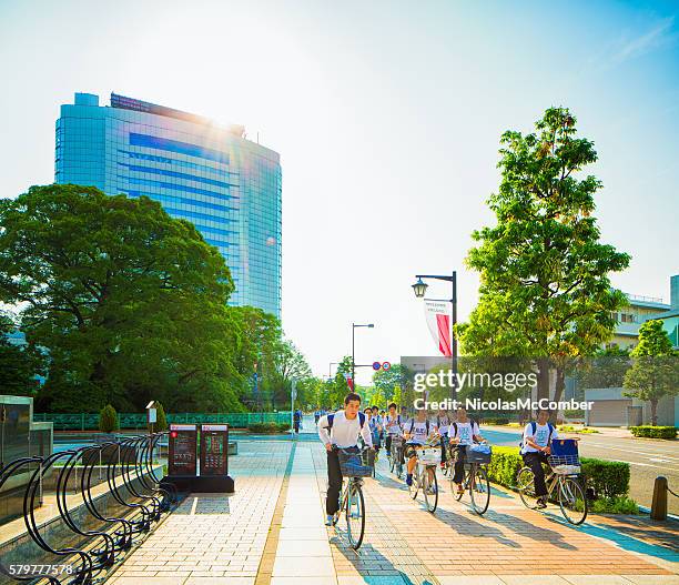 group of teenage cyclists on sidewalk in takasaki gunma japan - gunma stockfoto's en -beelden