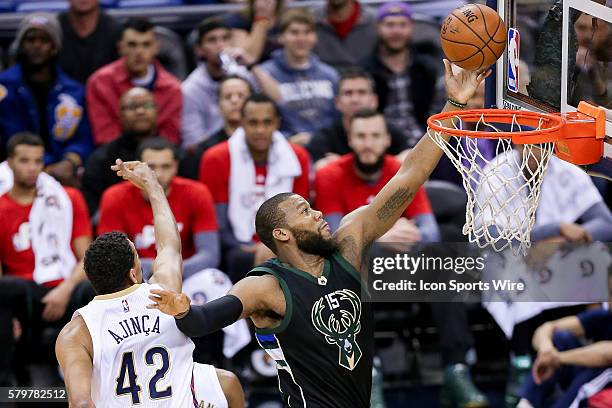 Milwaukee Bucks center Greg Monroe shoots a lay up against New Orleans Pelicans center Alexis Ajinca during the NBA game between the Milwaukee Bucks...