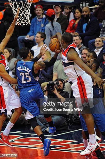 Washington Wizards center Kevin Seraphin blocks the shot of Minnesota Timberwolves guard Mo Williams at the Verizon Center in Washington, D.C. Where...