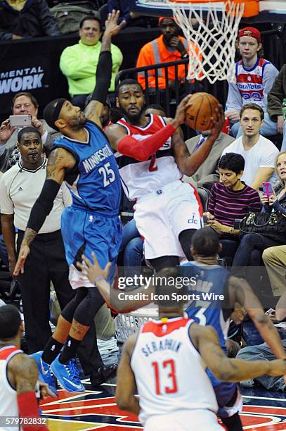 Washington Wizards guard John Wall passes to Washington Wizards center Kevin Seraphin agains the defense of Minnesota Timberwolves guard Mo Williams...