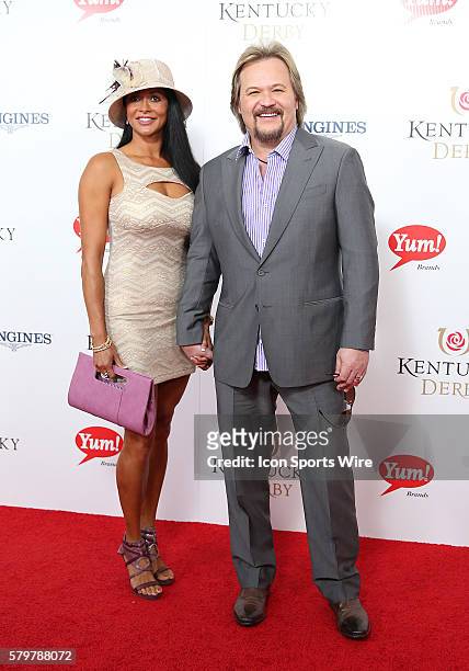 Musician Travis Tritt and his wife, Theresa, arrive on the red carpet at the 141st running of the Kentucky Derby at Churchill Downs in Louisville, KY.