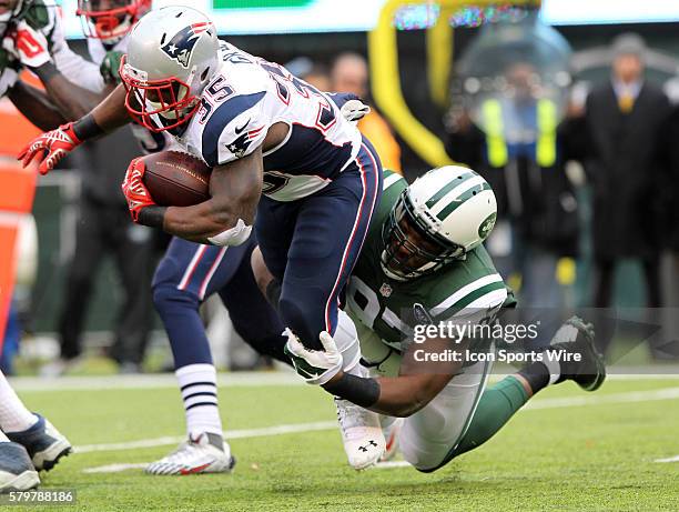 New England Patriots running back Jonas Gray is tackled by New York Jets outside linebacker Calvin Pace during a NFL game between the New England...