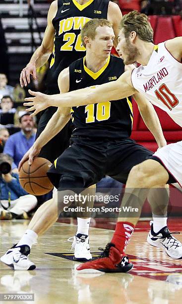 Iowa Hawkeyes guard Mike Gesell crosses up Maryland Terrapins forward Jake Layman during a match between the University of Maryland and the...