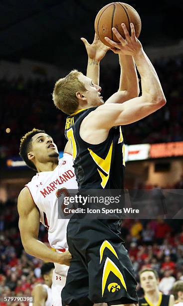 Iowa Hawkeyes guard Mike Gesell takes a shot over Maryland Terrapins guard Melo Trimble during a match between the University of Maryland and the...