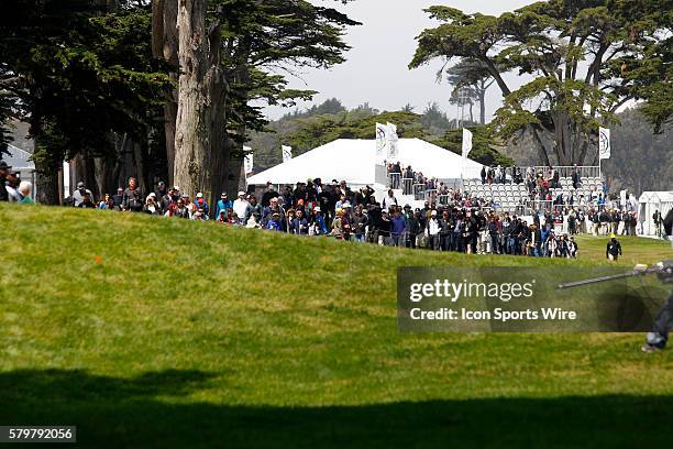 Throng of people start to move around the course at the start of the World Golf Championships at Harding Park in San Francisco, CA.