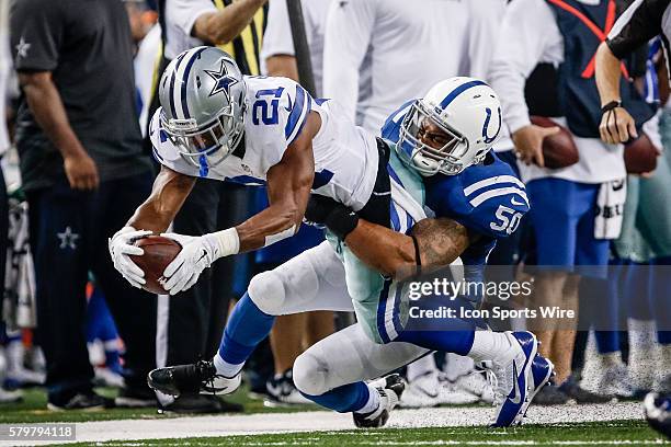 Indianapolis Colts Linebacker Jerrell Freeman [5662] holds on for the tackle as Dallas Cowboys Running Back Joseph Randle [18812] dives forward...