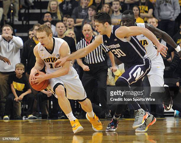 Iowa Hawkeyes guard Mike Gesell steals the ball from Northwestern guard Bryant McIntosh in the second half during a Big Ten Conference mens...