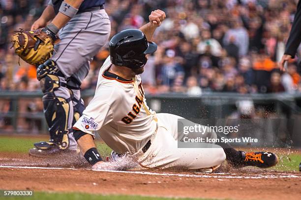 San Francisco Giants first baseman Brandon Belt slides home to score in the 2nd inning, off a one-run single by San Francisco Giants right fielder...