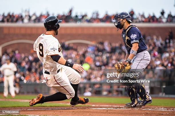 San Francisco Giants first baseman Brandon Belt slides home to score in the 2nd inning, off a one-run single bt San Francisco Giants right fielder...