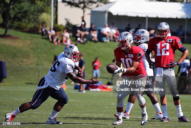 New England Patriots quarterback Jimmy Garoppolo hands off to New England Patriots running back Jonas Gray during New England Patriots training camp.