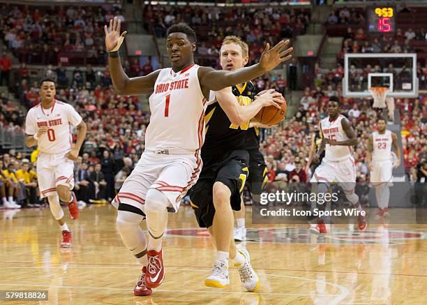 Jae'Sean Tate of the Ohio State Buckeyes guarding Mike Gesell of the Iowa Hawkeyes as he dribbles to the hoop during the game between the Ohio State...