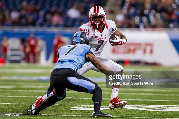 Rutgers Scarlet Knights running back Robert Martin carries the ball while trying to avoid being hit by North Carolina Tar Heels safety Tim Scott...