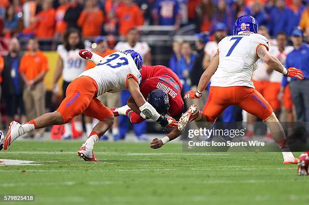 Arizona Wildcats quarterback Anu Solomon is hit by Boise State Broncos linebacker Gabe Perez during the first half of the Vizio Fiesta Bowl game...