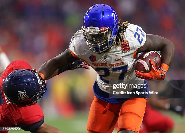 Boise State Broncos running back Jay Ajayi stiff arms Arizona Wildcats cornerback Cam Denson during the first quarter of the Vizio Fiesta Bowl game...