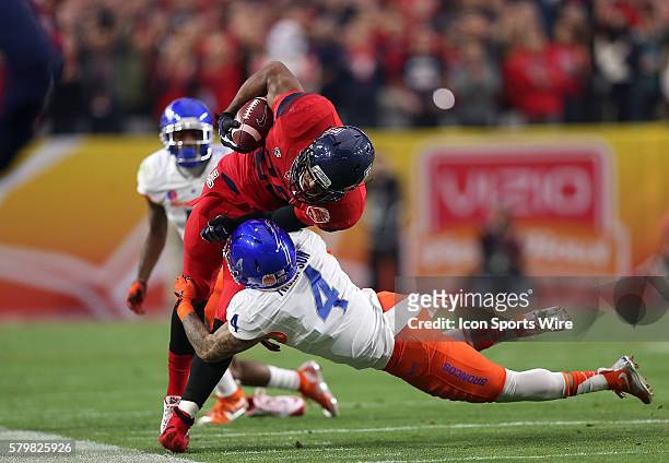Arizona Wildcats wide receiver Austin Hill is hit by Boise State Broncos safety Darian Thompson during the first half of the Vizio Fiesta Bowl game...