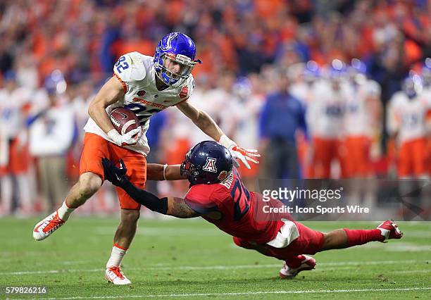 Boise State Broncos wide receiver Thomas Sperbeck is hit by Arizona Wildcats safety Jourdon Grandon during the first half of the Vizio Fiesta Bowl...