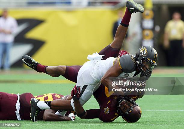 Jan 1, 2015; Orlando, FL USA; Minnesota Golden Gophers defensive back Damarius Travis tackles Missouri Tigers wide receiver Bud Sasser during the...