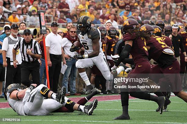 Missouri Tigers running back Marcus Murphy attempts to leap over Missouri Tigers offensive lineman Evan Boehm and Minnesota Golden Gophers defensive...