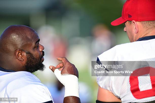 Houston Texans Defensive Tackle Vince Wilfork visits with Houston Texans Defensive End J.J. Watt before practice during the Texans Training Camp at...