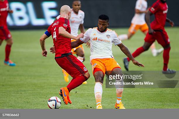 Toronto FC midfielder Michael Bradley battles for the ball against Houston Dynamo defender Jermaine Taylor during a game between the Toronto FC and...