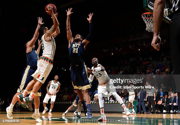 University of Miami guard Angel Rodriguez shoots against University of Pittsburgh forward Sheldon Jeter in Miami's 65-63 victory at BankUnited...