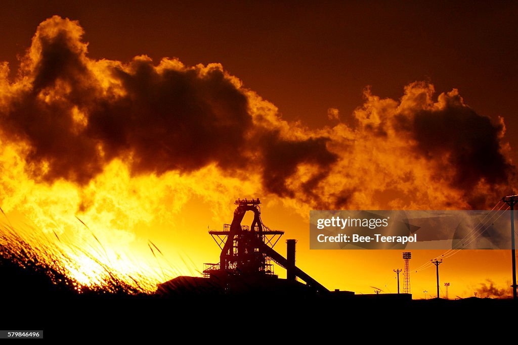 Illuminated steel plant and blast furnace at sunrise