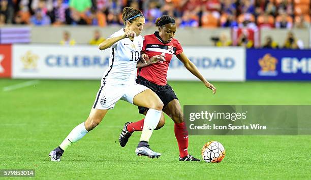 Trinidad & Tobago Defender Danielle Blair and United States Midfielder Carli Lloyd fight for ball control during the Women's Olympic qualifying...