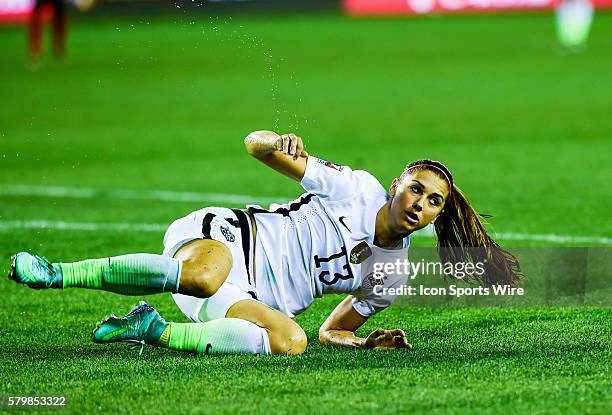 United States Forward Alex Morgan reacts to getting knocked off the ball during the Women's Olympic qualifying soccer match between USA and Trinidad...