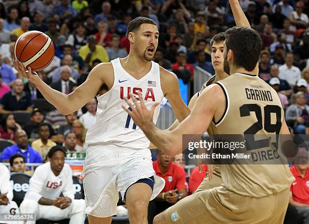 Klay Thompson of the United States tries to pass from the baseline against Patricio Garino of Argentina during a USA Basketball showcase exhibition...