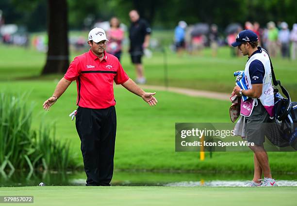 Patrick Reed prepares to drop on as his approach shot landed next to the hole but spun back into the water during final round action of the Crowne...