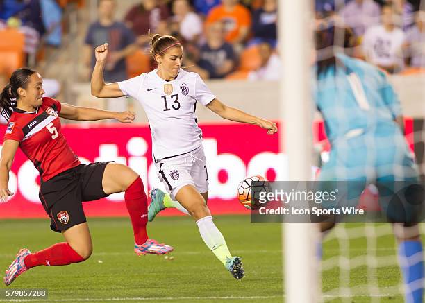 Forward Alex Morgan scores a goal during the Women's Olympic semi-final qualifying match between USA and Trinidad & Tobago at BBVA Compass Stadium in...
