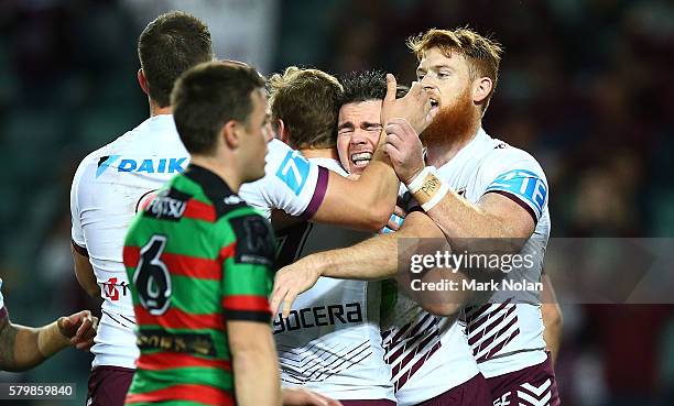 Jamie Lyon of the Eagles celebrates scoring a try with team mates during the round 20 NRL match between the South Sydney Rabbitohs and the Manly Sea...